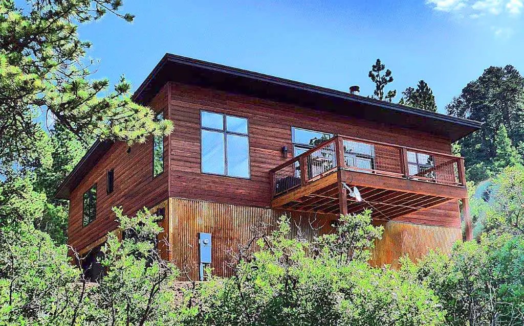 Aspen home with wood siding and a side deck